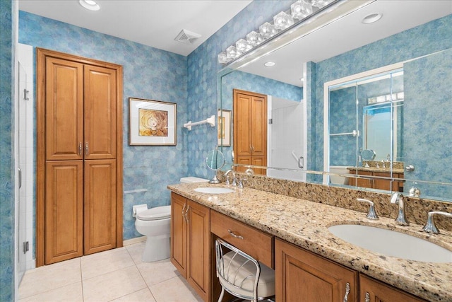 bathroom featuring tile patterned floors, vanity, toilet, and a shower with shower door