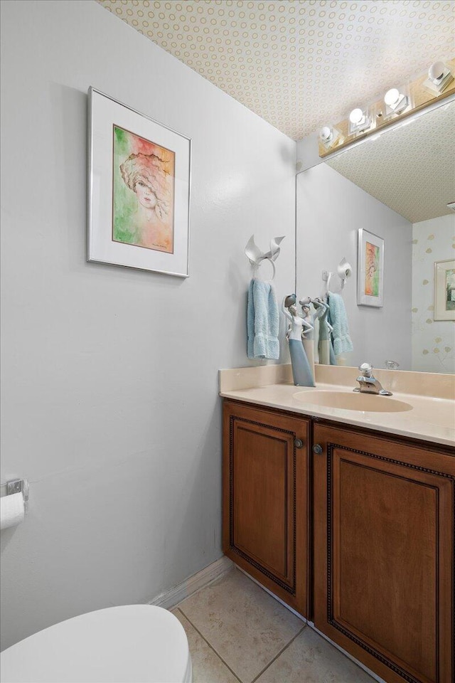 bathroom featuring tile patterned floors, vanity, toilet, and a textured ceiling