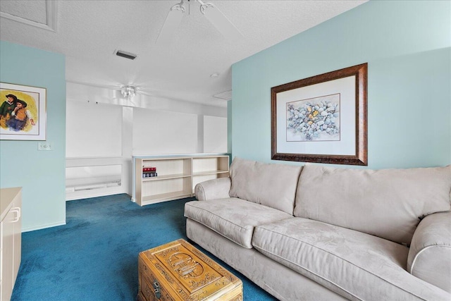 carpeted living room with a textured ceiling and ceiling fan