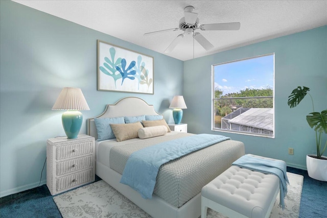 carpeted bedroom with a textured ceiling and ceiling fan