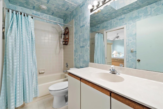 full bathroom with vanity, tile patterned floors, ceiling fan, toilet, and shower / tub combo