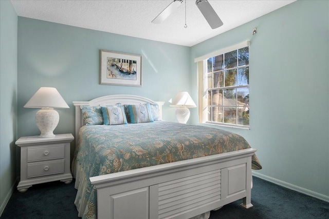 carpeted bedroom featuring a textured ceiling and ceiling fan