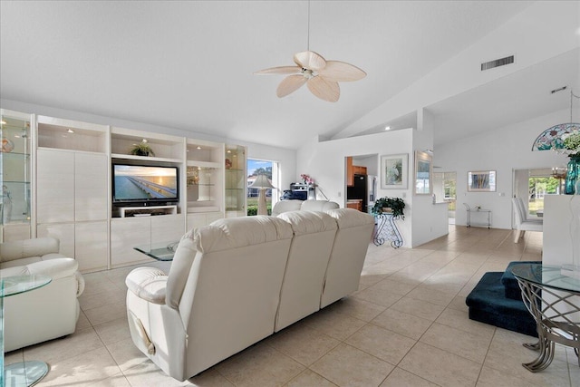 tiled living room featuring ceiling fan and high vaulted ceiling