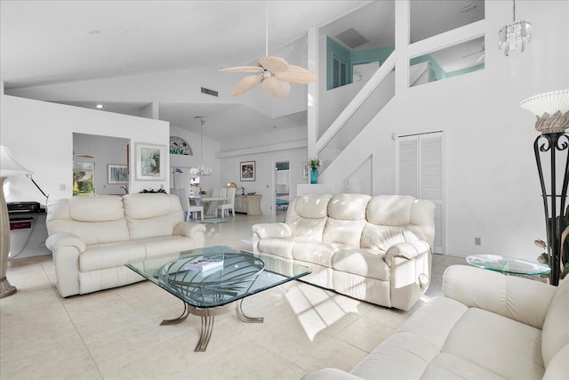 living room featuring light tile patterned floors, ceiling fan with notable chandelier, and high vaulted ceiling