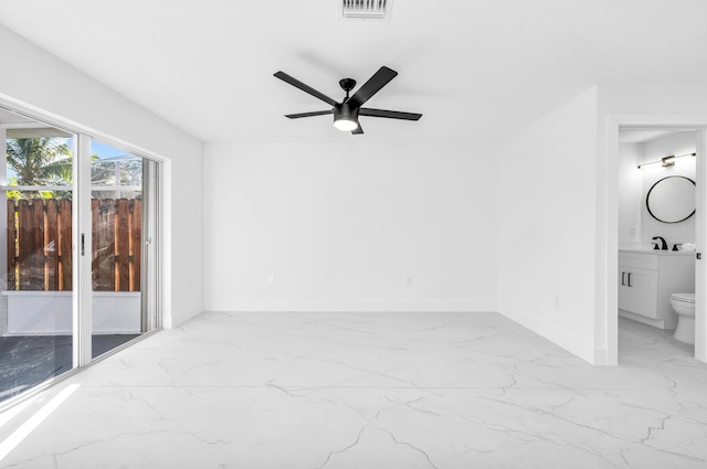 unfurnished room featuring ceiling fan and sink