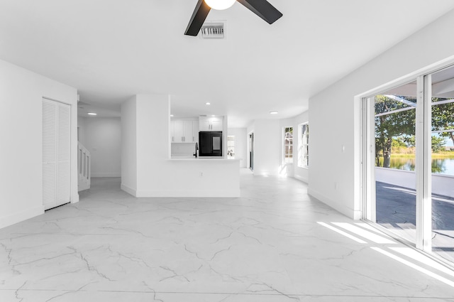 unfurnished living room featuring ceiling fan