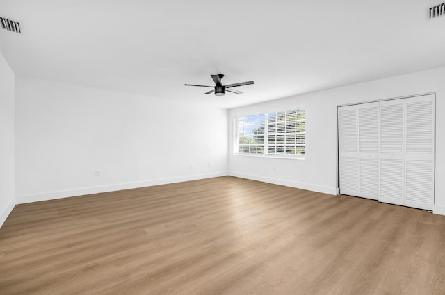 unfurnished bedroom with ceiling fan and light wood-type flooring