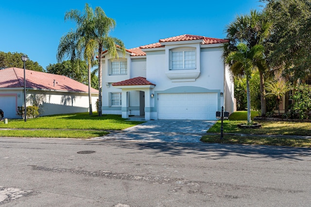 mediterranean / spanish-style home with a front yard and a garage