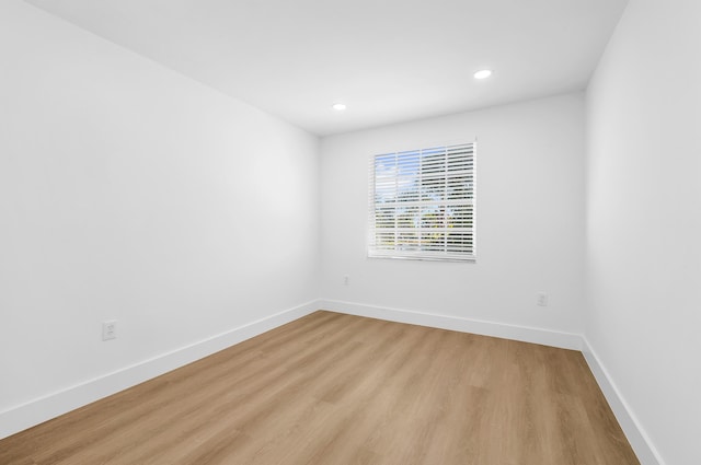 unfurnished room with light hardwood / wood-style flooring