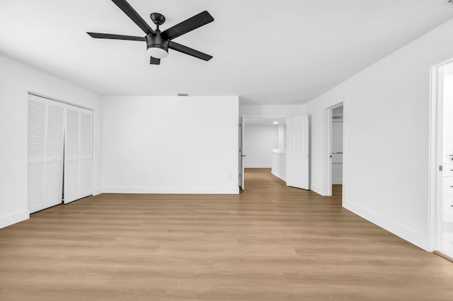 unfurnished bedroom featuring ceiling fan, a closet, and light hardwood / wood-style flooring