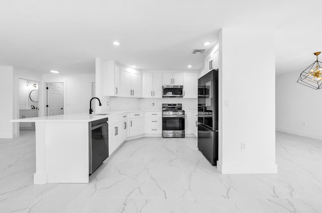 kitchen with kitchen peninsula, stainless steel appliances, sink, white cabinetry, and hanging light fixtures