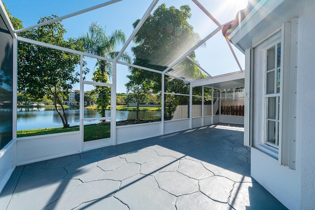 unfurnished sunroom featuring a water view and a healthy amount of sunlight