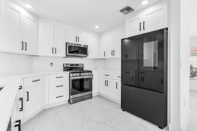 kitchen featuring white cabinets and appliances with stainless steel finishes