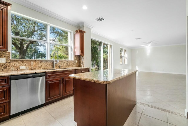 kitchen featuring dishwasher, sink, ceiling fan, light tile patterned floors, and light stone counters