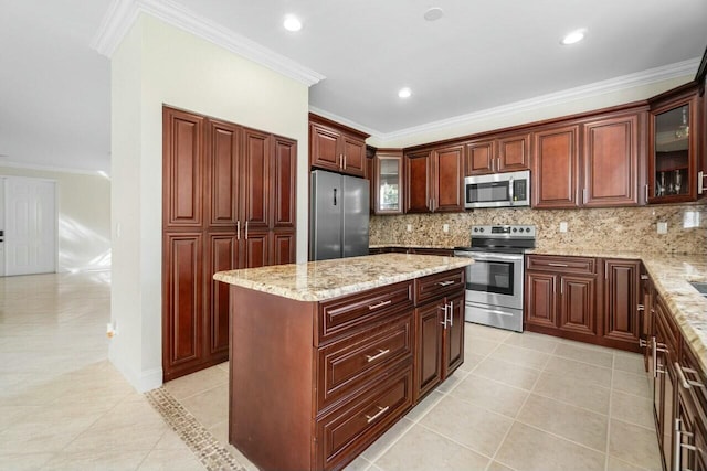 kitchen with decorative backsplash, a center island, ornamental molding, and stainless steel appliances