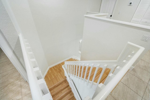 stairs featuring hardwood / wood-style floors