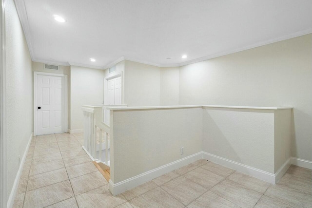 interior space featuring ornamental molding and light tile patterned flooring