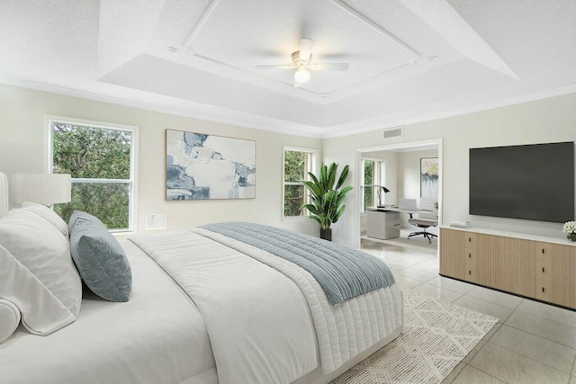 tiled bedroom with ceiling fan, multiple windows, and a tray ceiling