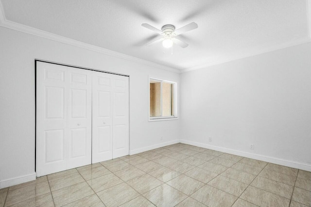 unfurnished bedroom featuring ceiling fan, a closet, light tile patterned floors, and ornamental molding