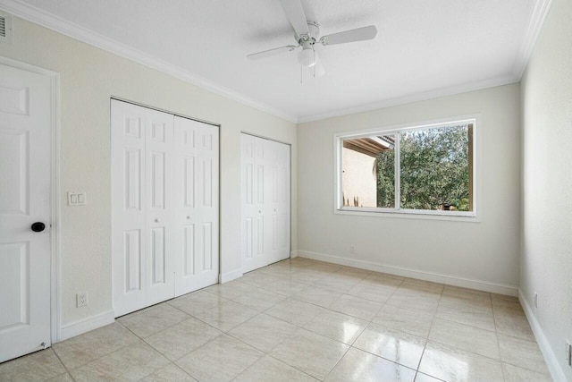 unfurnished bedroom with multiple closets, ceiling fan, and ornamental molding