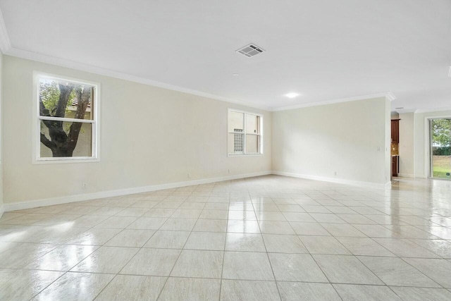 tiled spare room featuring ornamental molding