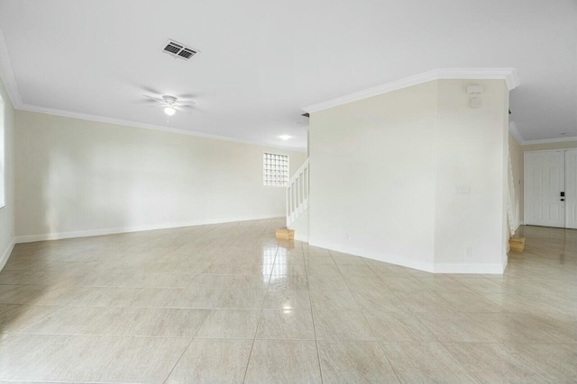 empty room featuring ceiling fan and crown molding