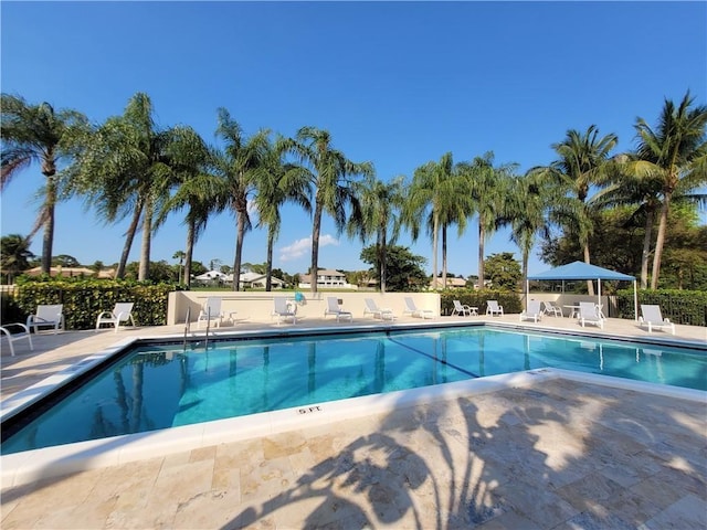 community pool featuring a patio area and fence