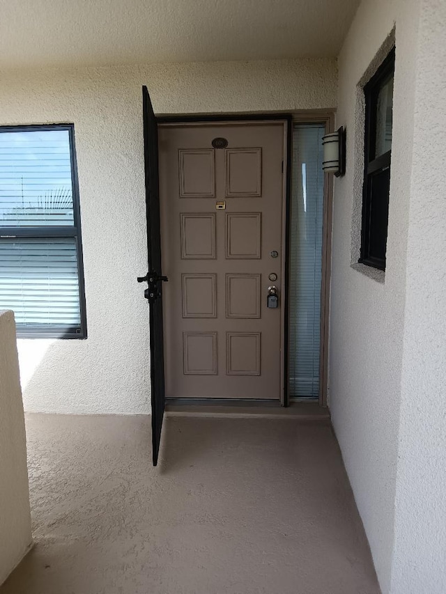 entrance to property with stucco siding