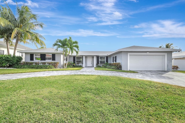 ranch-style house with a garage and a front lawn