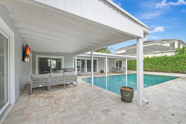 view of pool with outdoor lounge area and a patio