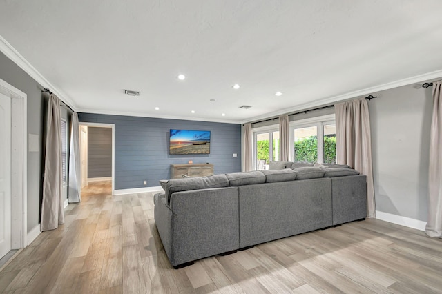 living room with light hardwood / wood-style floors and ornamental molding