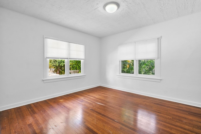 spare room with wood-type flooring and a textured ceiling