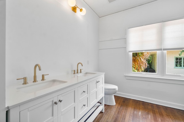 bathroom featuring hardwood / wood-style flooring, vanity, and toilet