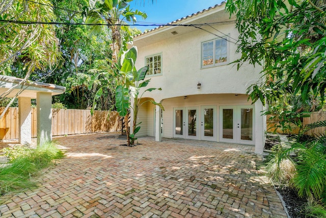 rear view of house featuring french doors