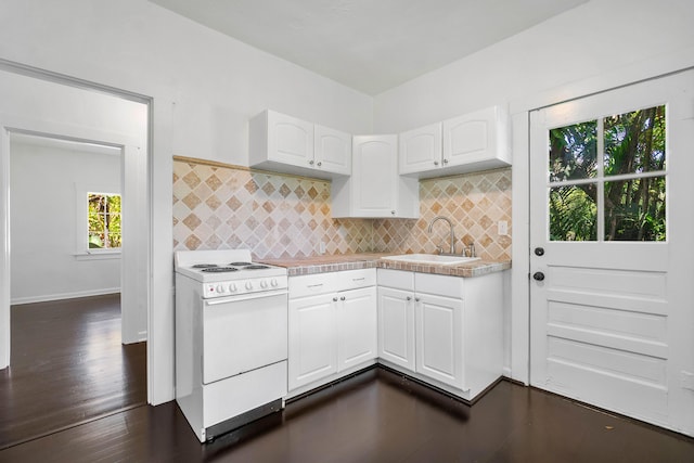 kitchen featuring white cabinets, plenty of natural light, white range oven, and sink