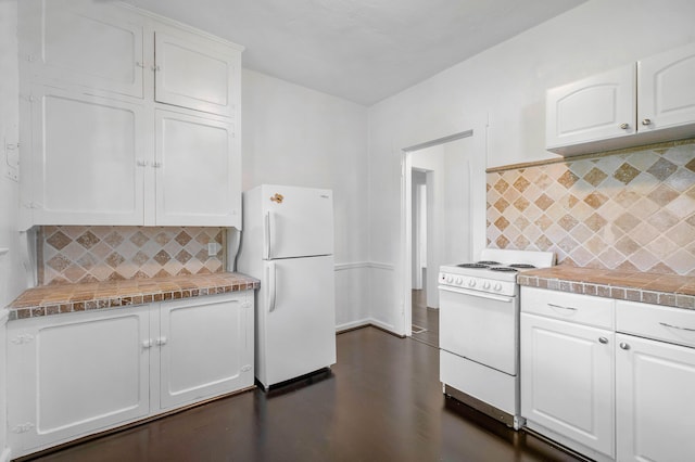 kitchen featuring backsplash, white cabinets, and white appliances