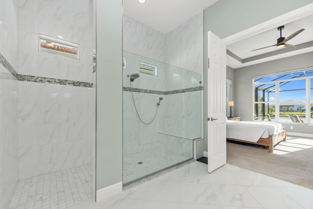 bathroom with a tile shower and ceiling fan