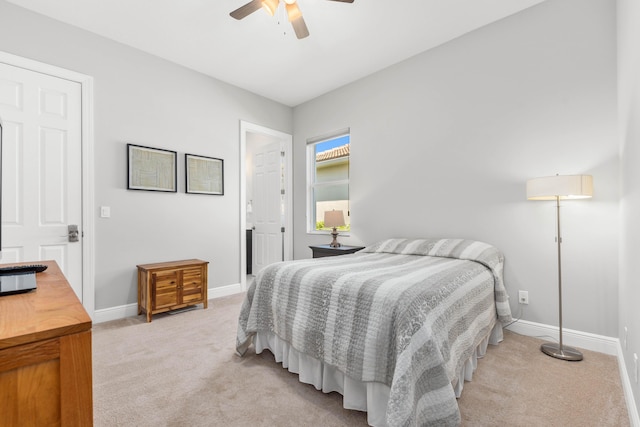 bedroom with ceiling fan and light carpet