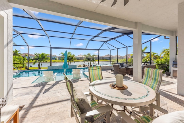 view of patio / terrace with a lanai and a water view