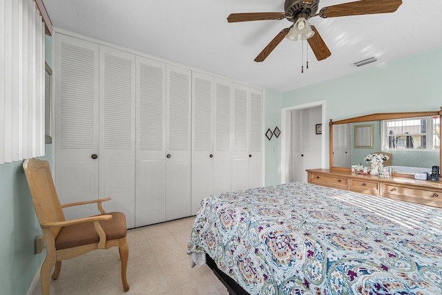 tiled bedroom featuring a closet and ceiling fan