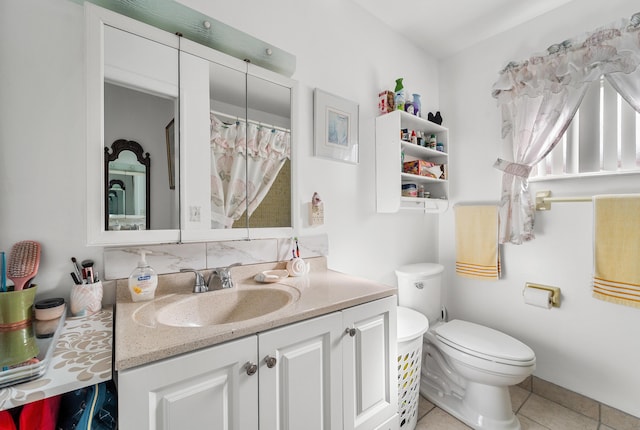 bathroom with tile patterned flooring, vanity, and toilet