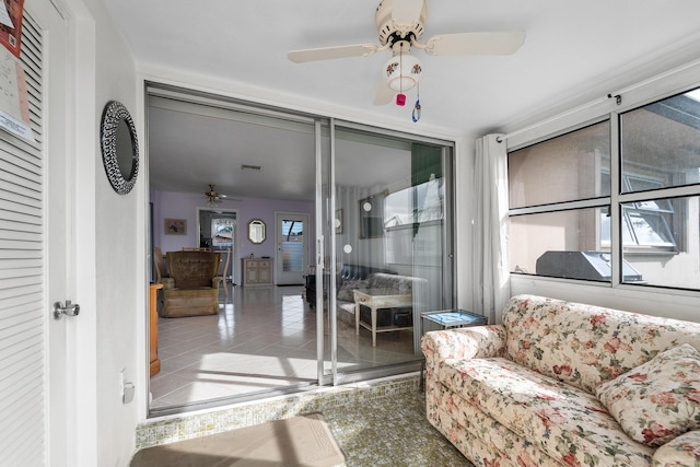 living room with ceiling fan and a healthy amount of sunlight