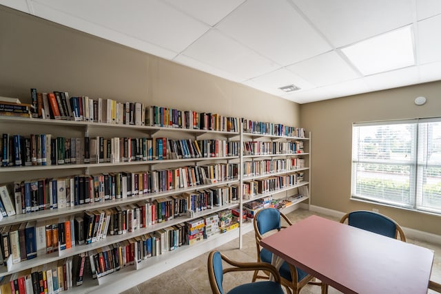 office space with light tile patterned floors and a paneled ceiling