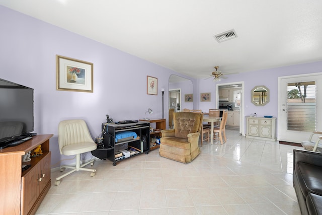 living room featuring light tile patterned floors and ceiling fan