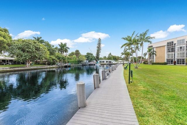 view of dock featuring a yard and a water view