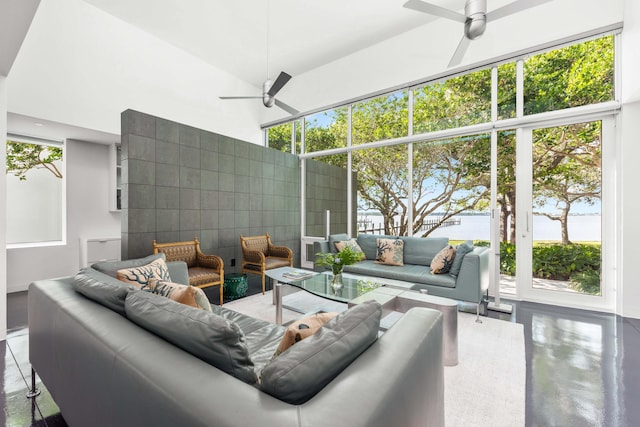 interior space with ceiling fan and a towering ceiling