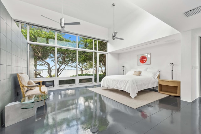 bedroom with multiple windows, a high ceiling, and ceiling fan