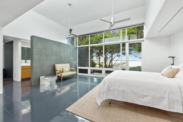 bedroom featuring ceiling fan, a high ceiling, and ensuite bath