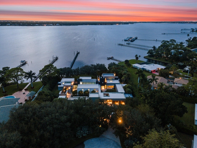 aerial view at dusk with a water view