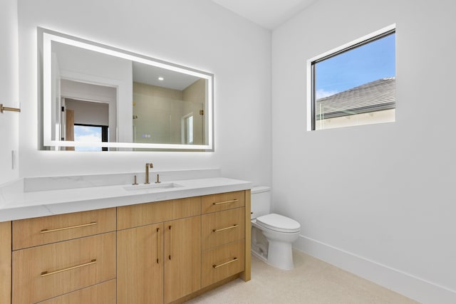 bathroom featuring vanity, toilet, and a shower with shower door